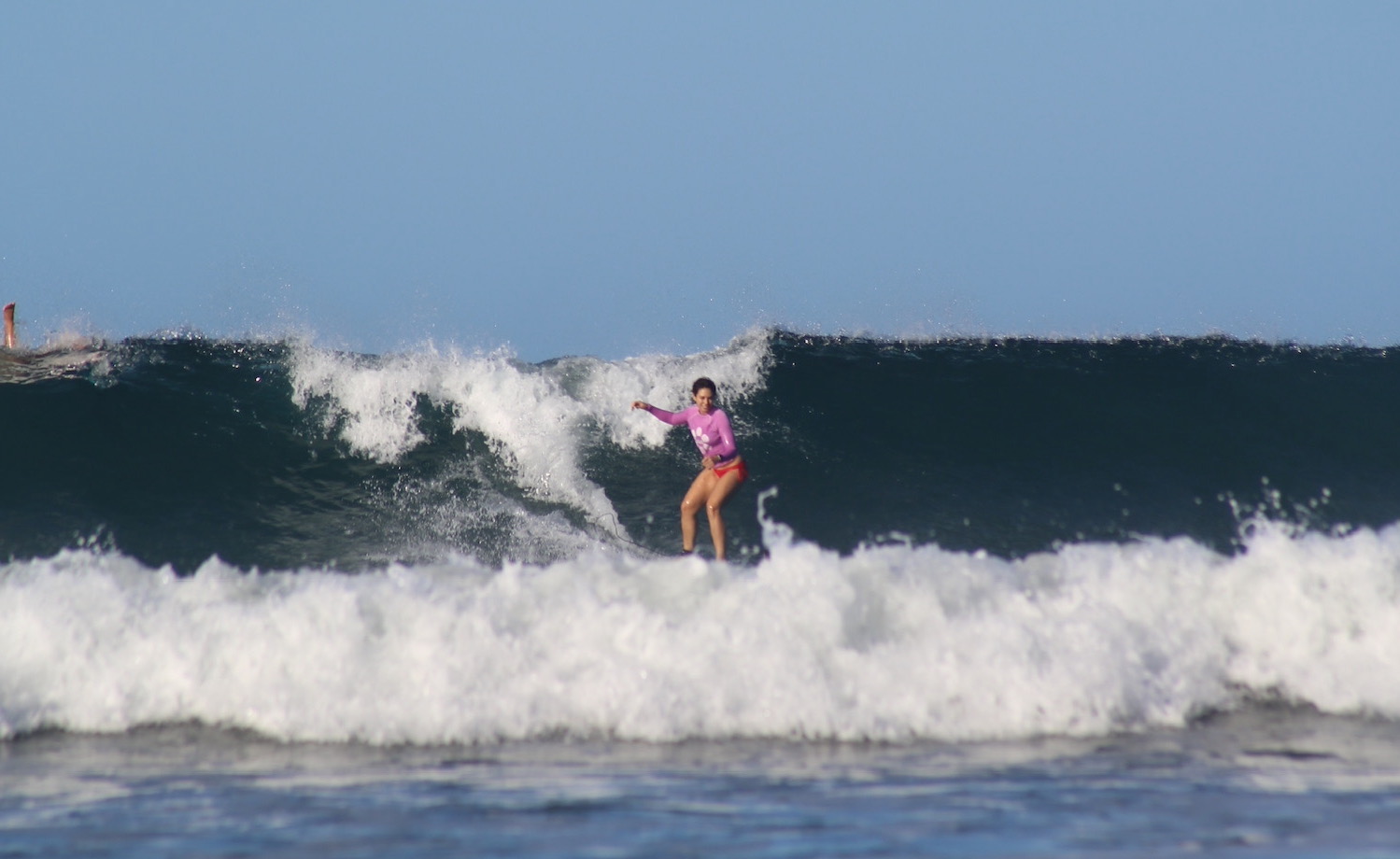 melanie looking happy while surfing in Playa Guiones, Costa Rica